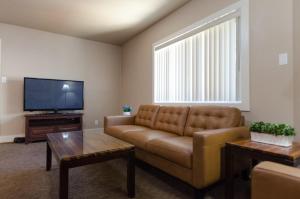 a living room with a couch and a flat screen tv at Updated condo in Logan in Logan