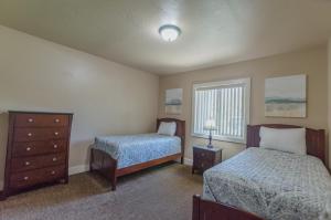 a bedroom with two beds and a dresser at Updated condo in Logan in Logan