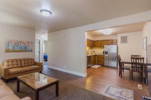a living room with a couch and a table and a kitchen at Updated condo in Logan in Logan