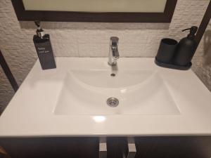 a white sink with a faucet on a counter at Miramar Playa in La Playa de la Torre de Piles +19 photos