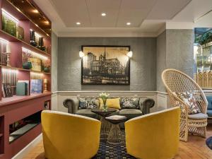a waiting room with a couch and chairs at Mercure Paris Notre Dame Saint Germain des Prés in Paris
