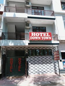 a hotel down town sign on the side of a building at Hotel Downtown in Kānpur +7 photos