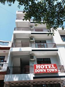 a hotel down town sign on the side of a building at Hotel Downtown in Kānpur