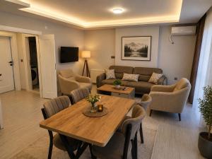 a living room with a table and a couch at Airport Deluxe Suites Otel in Trabzon