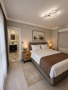 a bedroom with a large bed and a bathroom at Airport Deluxe Suites Otel in Trabzon