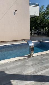 an apple sign on a building next to a swimming pool at TWINS DREAMs HOUSE in Bar