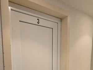 a white door with the on it at B&B Mercator in Ostend