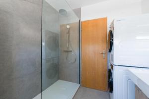 a shower with a glass door in a bathroom at 21 Pure relaxation Apartment in Memmingerberg
