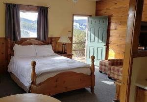a bedroom with a bed and a large window at Sundance Lodge in Nederland