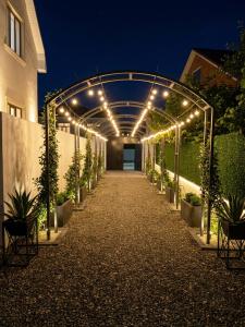 a walkway with lights and potted plants on it at A-frame-WHITE HOUSE-I in Qusar