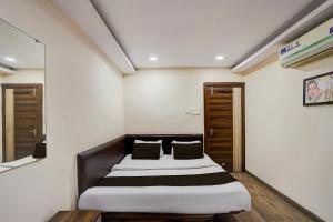 a bedroom with a large bed in a room at Hotel O Hotel Krishna's Residency in Indore