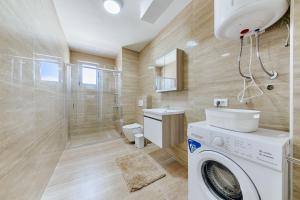a bathroom with a washing machine and a toilet at Malik Bay RESIDENTS in Bar +33 photos