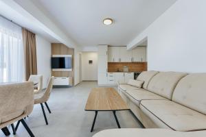 a living room with a couch and a table at Malik Bay RESIDENTS in Bar