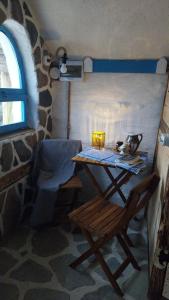 a table and a chair in a room with a window at Nook Hill in Comarnic +21 photos