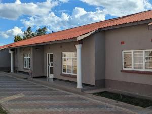 a small house with a red roof at Maneya Apartments in Kabwe