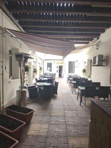 a restaurant with tables and chairs and a patio at Penzion Labužník in Lovosice