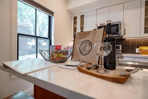 a kitchen counter with a bottle of wine and a glass at Downtown Truckee Walkable 6 Bed Pet Friendly in Truckee +39 photos