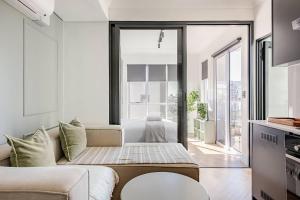 a living room with a couch and a large window at The Lookout in Cape Town