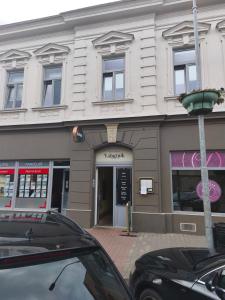 a building with a car parked in front of it at Penzion Labužník in Lovosice