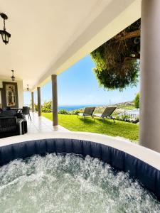 a hot tub in the backyard of a house at Casa Conduto in Ponta do Sol