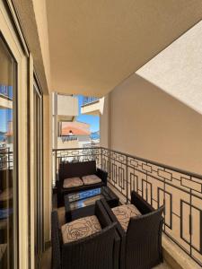 a balcony with two chairs and a couch on it at Azure Residence in Pržno