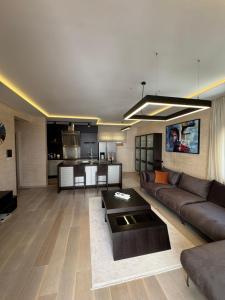 a living room with a couch and a table at Azure Residence in Pržno