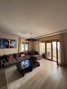 a living room with a couch and a coffee table at Azure Residence in Pržno