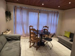 a room with a table and two chairs and a couch at B&B Mercator in Ostend