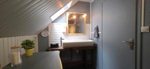 a bathroom with a sink and a mirror at Murat - Le Duplex By Murat in Murat +24 photos