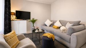 a living room with a couch and a tv at Terra Verde in Račički Brijeg