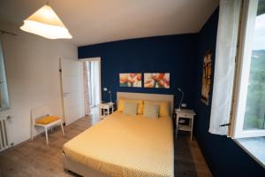 a bedroom with a bed and a blue wall at Casa Rosella in Sapri