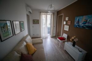 a living room with a couch and a chair at Casa Rosella in Sapri