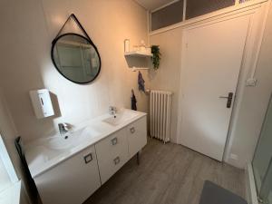a bathroom with a sink and a mirror at Murat - Le Duplex By Murat in Murat
