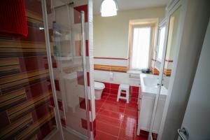 a bathroom with a shower and a toilet and a sink at Casa Rosella in Sapri