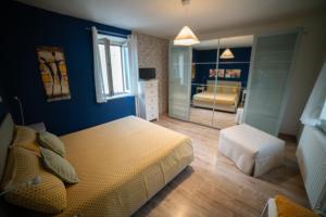 a bedroom with a king sized bed and a room with a bedroomicterictericter at Casa Rosella in Sapri +18 photos