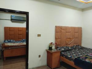 a bedroom with a bed and a mirror in it at Hotel Ravi Park Lahore in Lahore