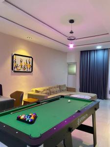 a living room with a pool table in it at Meg Apartment in Asipa