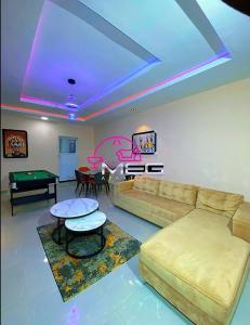a living room with a couch and a pool table at Meg Apartment in Asipa
