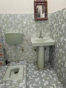a bathroom with a sink and a toilet at Hotel Ravi Park Lahore in Lahore