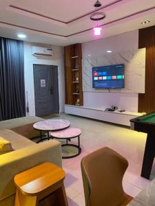 a living room with a pool table and a tv at Meg Apartment in Asipa