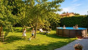 a group of children playing around a swimming pool at Terra Verde in Račički Brijeg