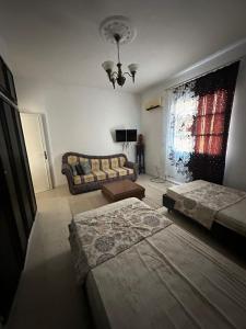 a living room with two beds and a couch at Appartement henda 04 in Sousse
