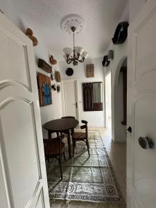 a dining room with a table and chairs at Appartement henda 04 in Sousse