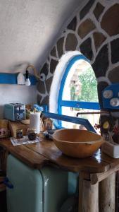 a kitchen with a counter with a wooden bowl on it at Nook Hill in Comarnic