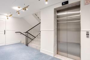 a hallway with a glass door leading to a staircase at The Lookout in Cape Town