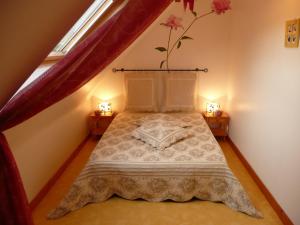 バダンにあるLa Maison des Îles & Spa privatifのベッドルーム1室(両側にランプ2つ付)