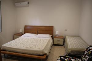 a bedroom with a bed and two night stands at Sotto il Borgo Apartments in Iesi +14 photos