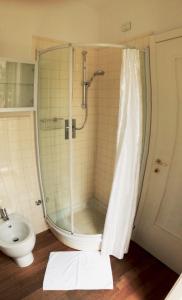 a bathroom with a shower and a toilet and a sink at Sotto il Borgo Apartments in Iesi
