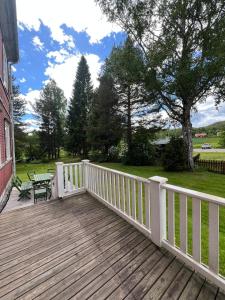 a wooden deck with a bench on it at Anders-Pers, The apartment downstairs in Järvsö