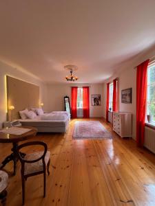 a large living room with a bed and a table at Anders-Pers, The apartment downstairs in Järvsö